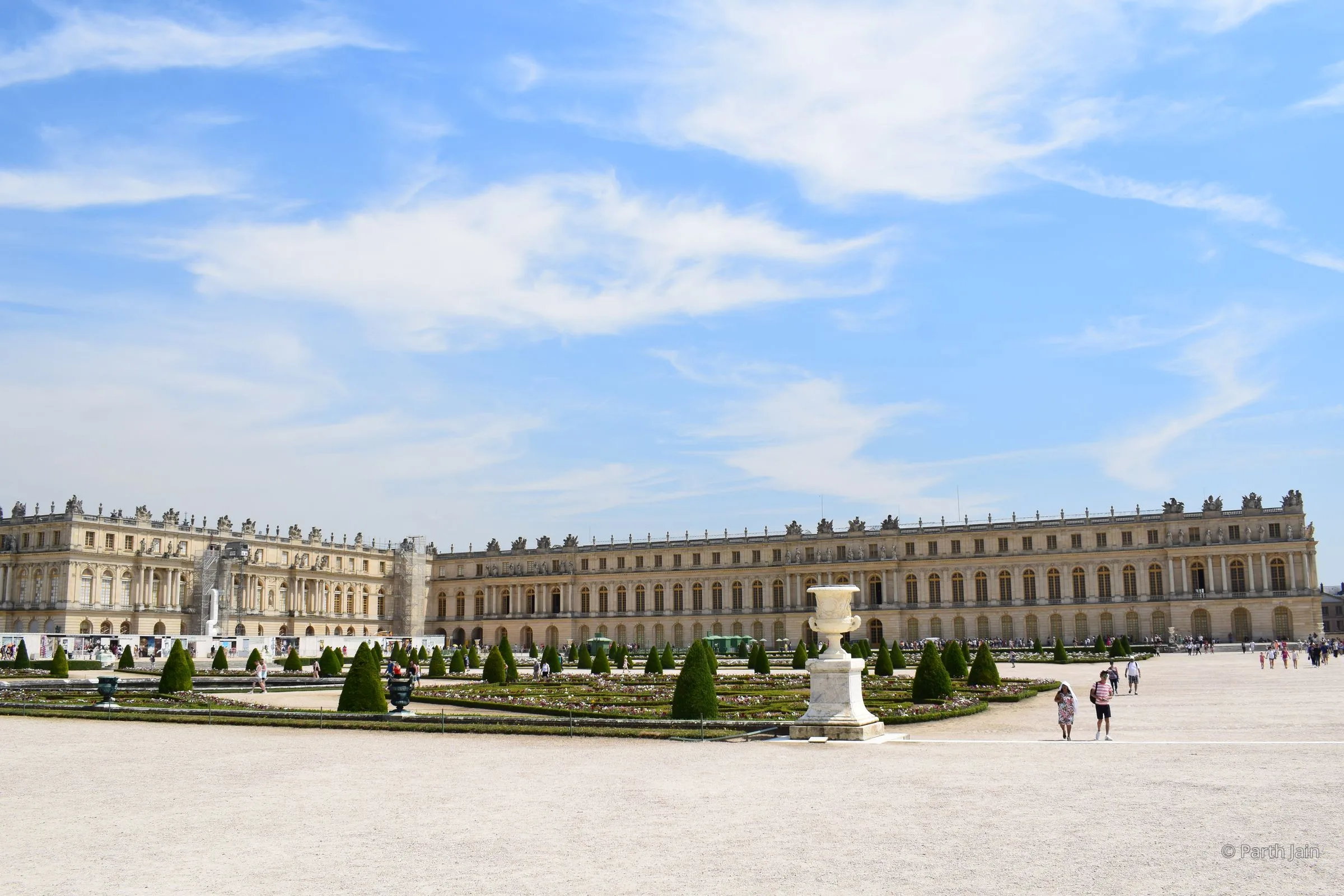 The garden façade of the Palace of Versailles, with the parterre and trimmed hedges in front.