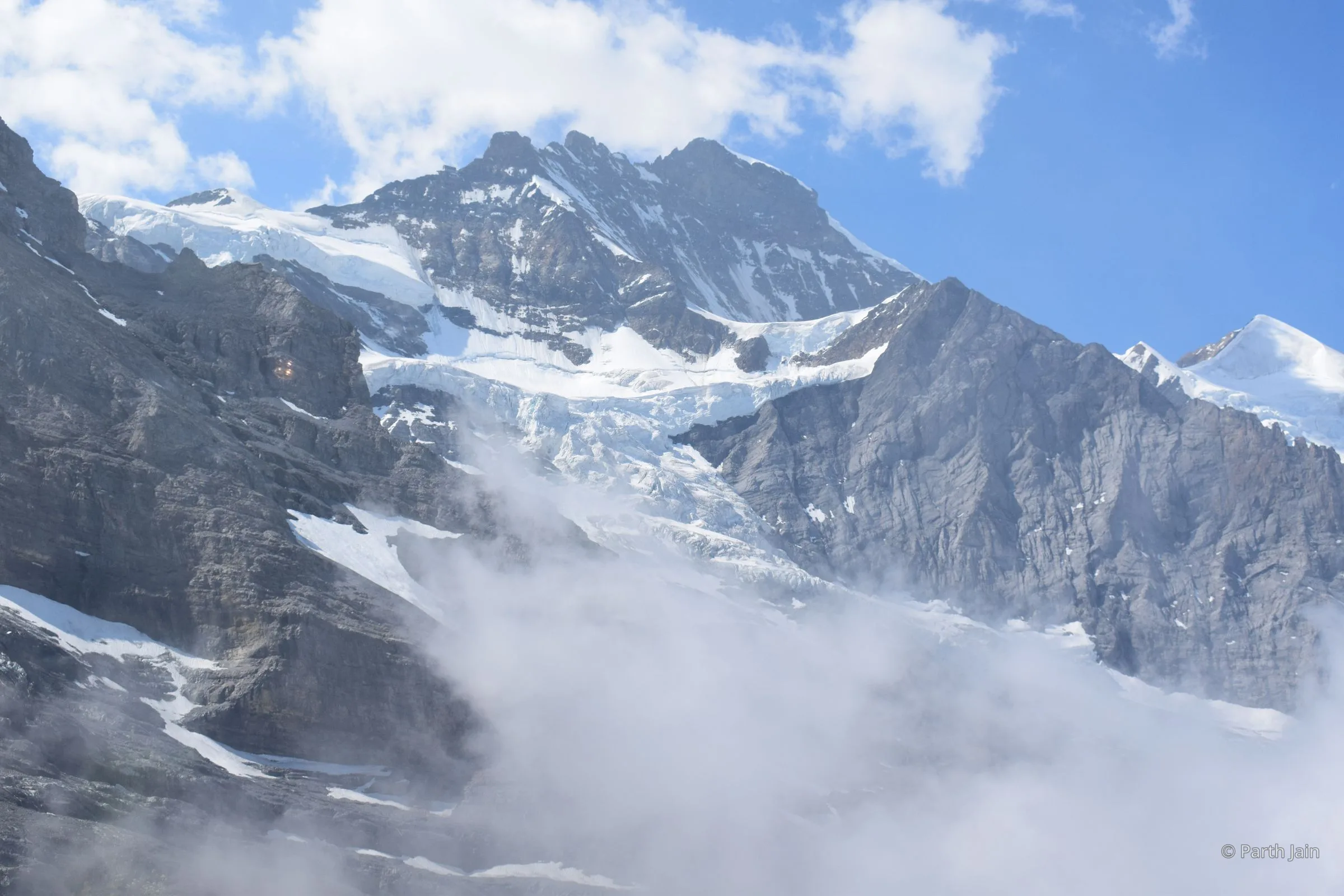 Close detail of the Jungfrau ridge with wind-carved snow.