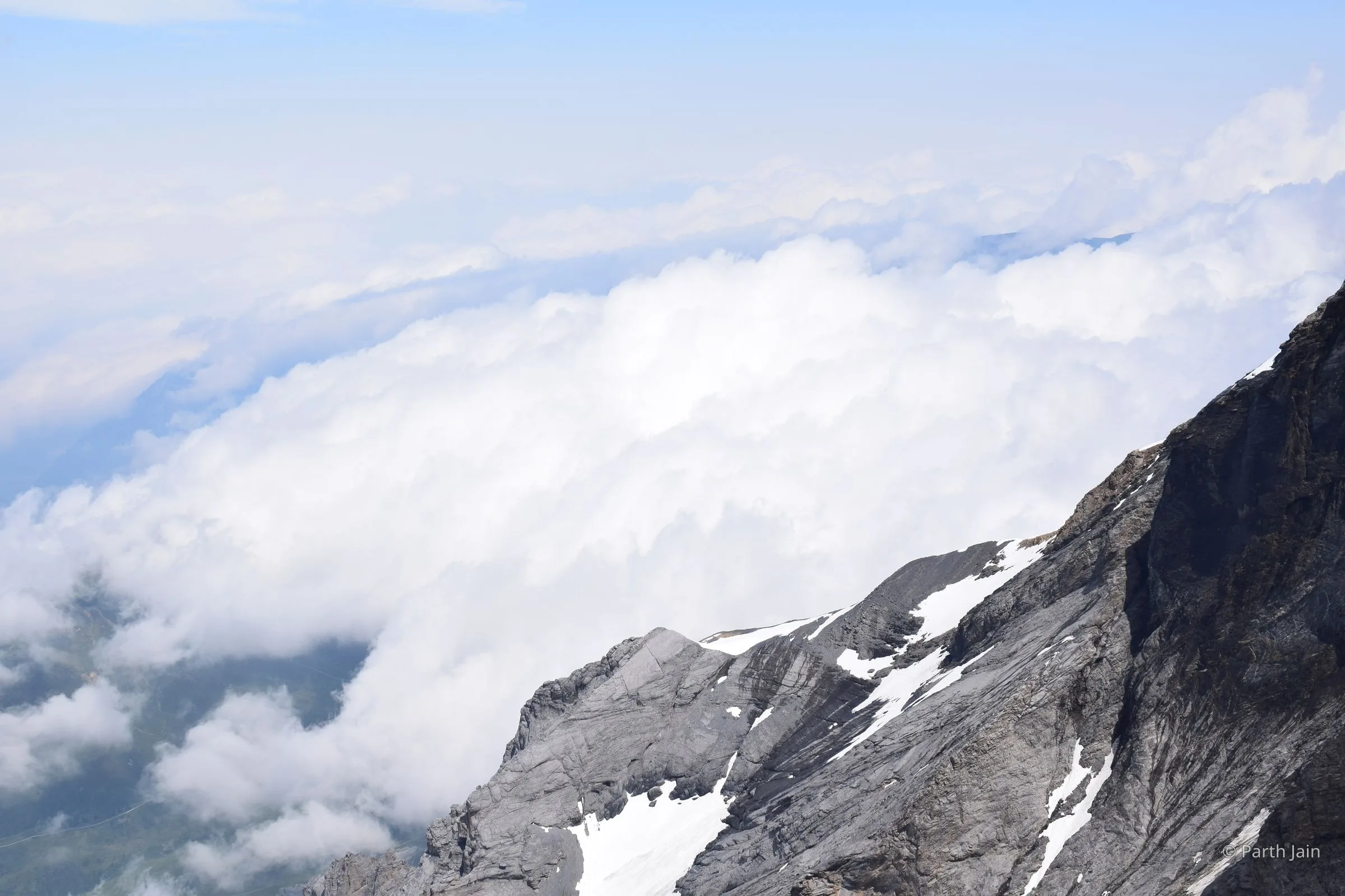 Looking down through a clearing in the cloud onto the valley below.