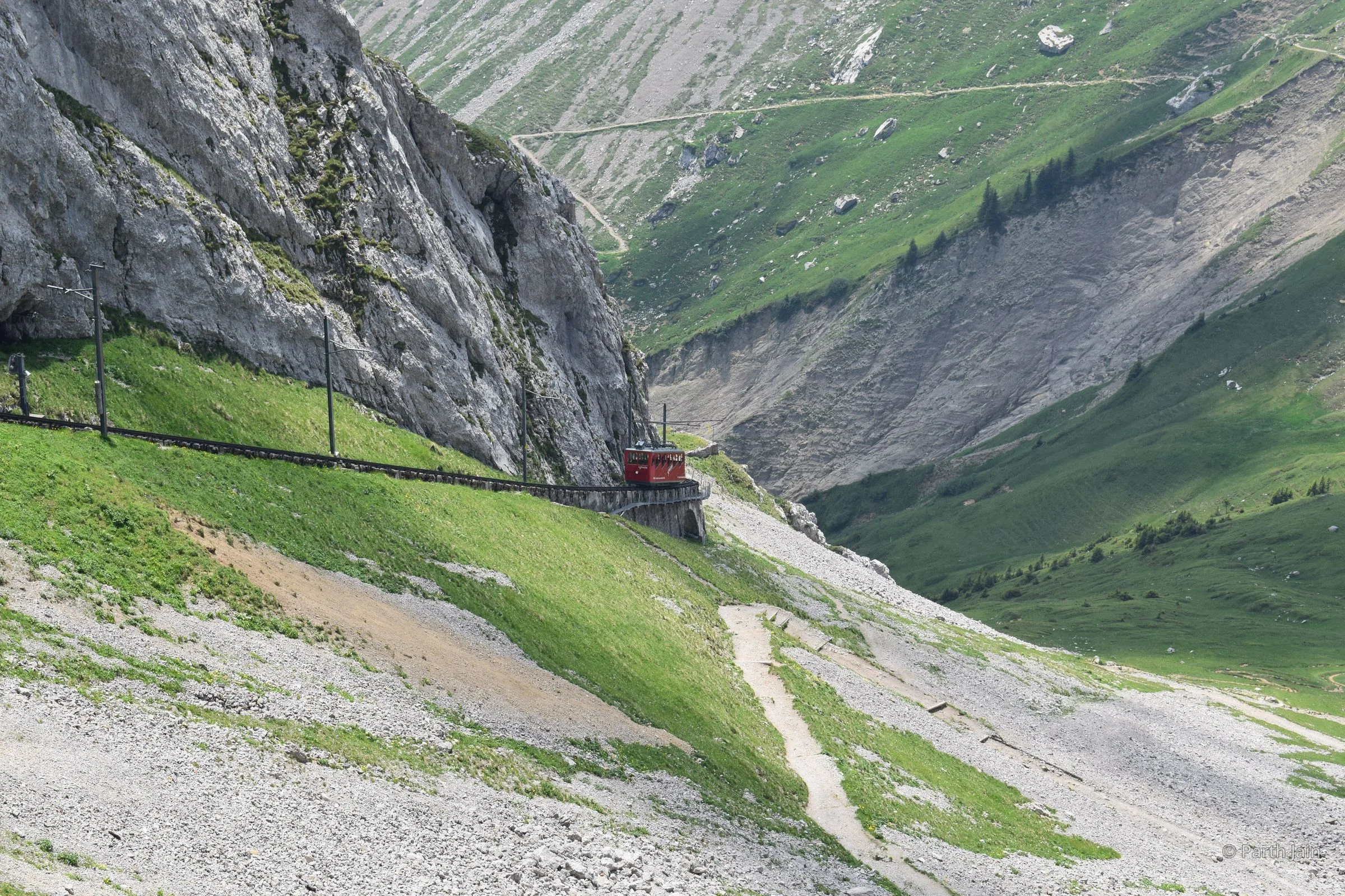 The Pilatus cogwheel train hugging a near-vertical cliff face.